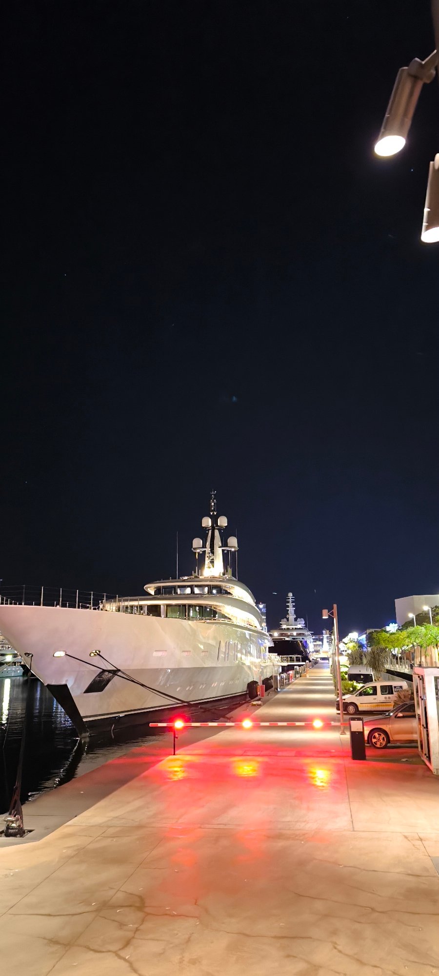 Luxury yacht docked at Barcelona marina during evening hours