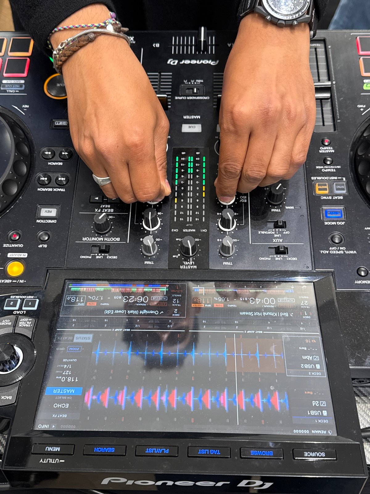DJ operates mixing console with electronic tracks in Munich