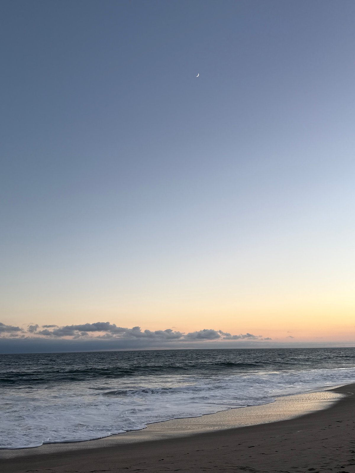 Sunset evening on a Malibu beach with people and waves