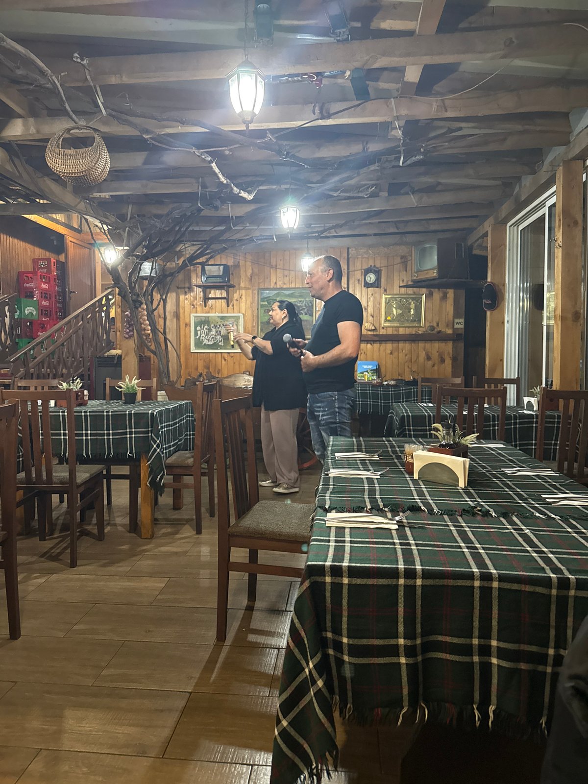 Duo performs at rustic restaurant with wooden beam decor