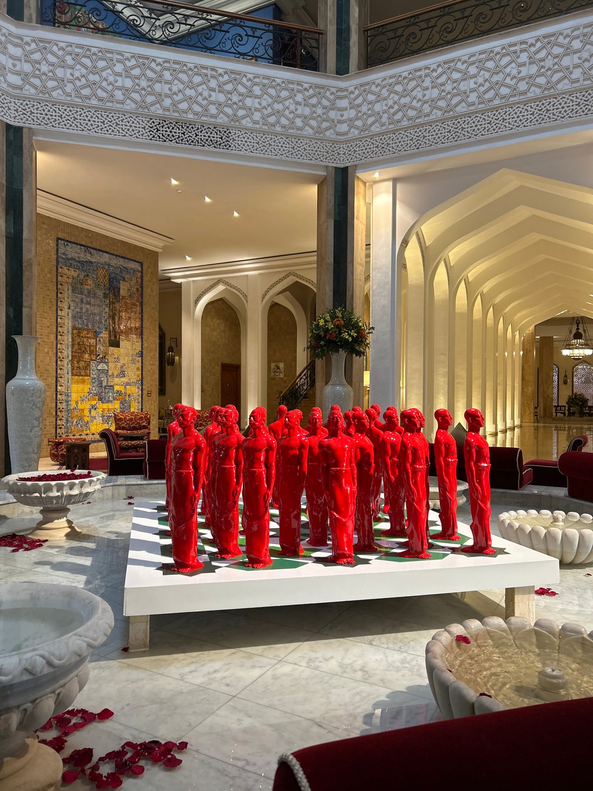 Visitor documents ornate architecture at Bahia Palace, Marrakesh