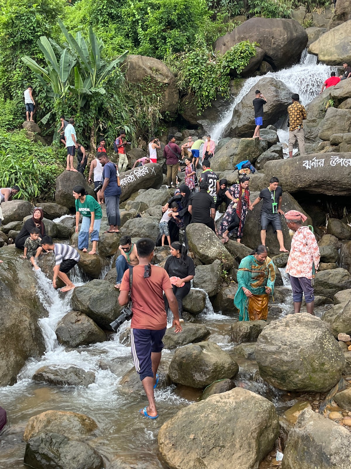 Crowds enjoy the rocky waterfall at Jaflong, Bangladesh