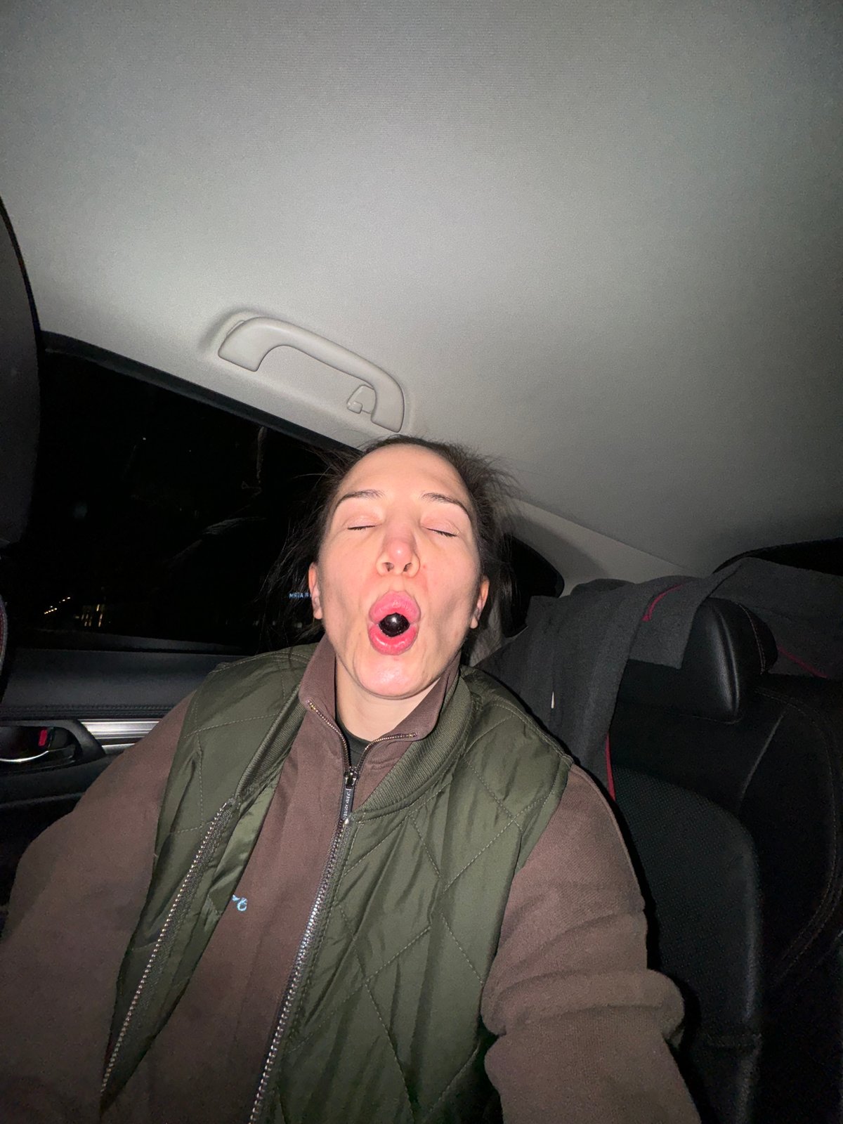 Young person photographed inside car at night in Moscow