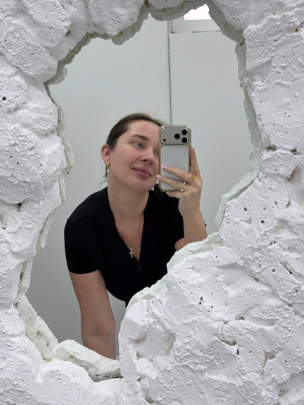 Woman takes mirror selfie in Moscow interior space
