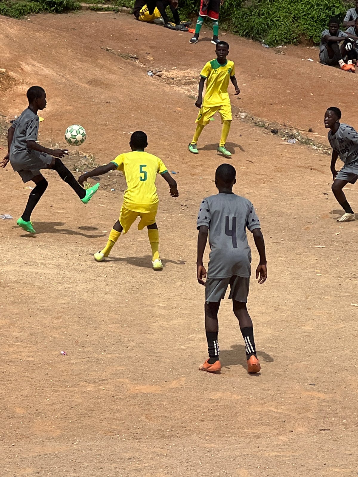 Pickup soccer on a dusty field in Jos, Nigeria