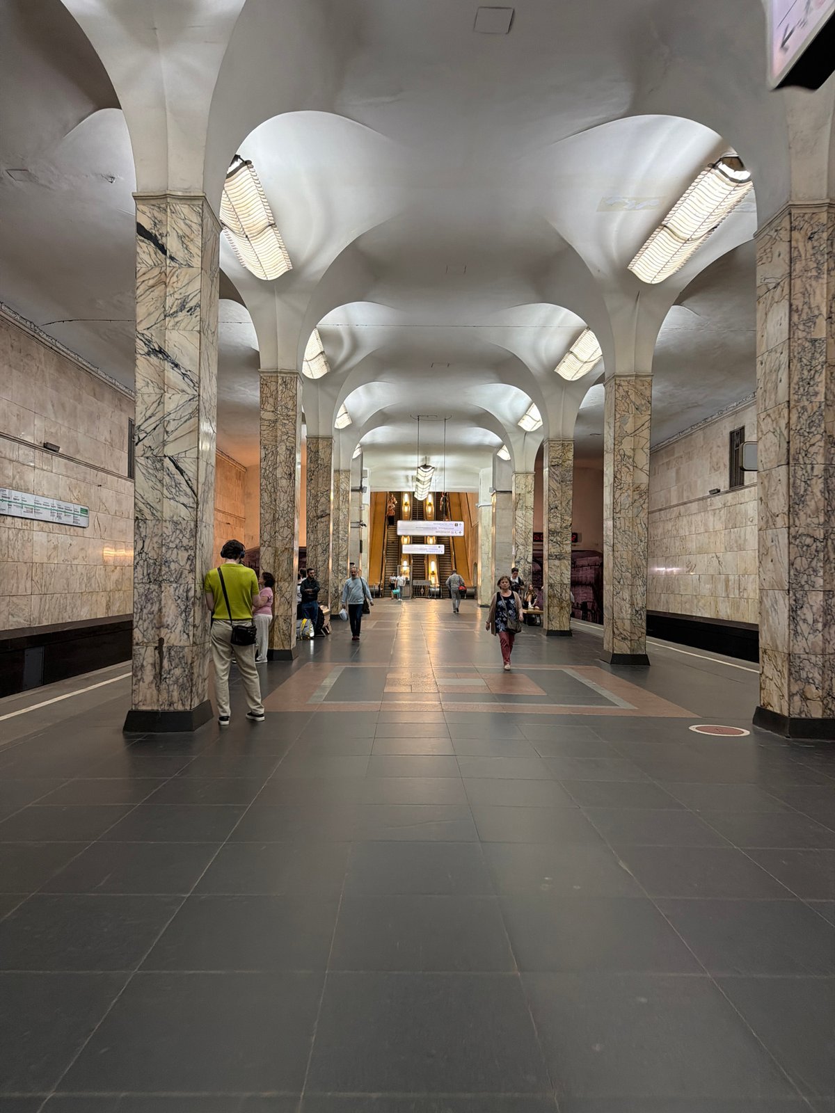 Inside a grand metro system, passengers move through ornate stations
