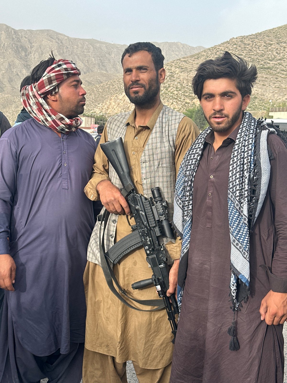 Armed men documented in outdoor gathering in Kolpur, Pakistan