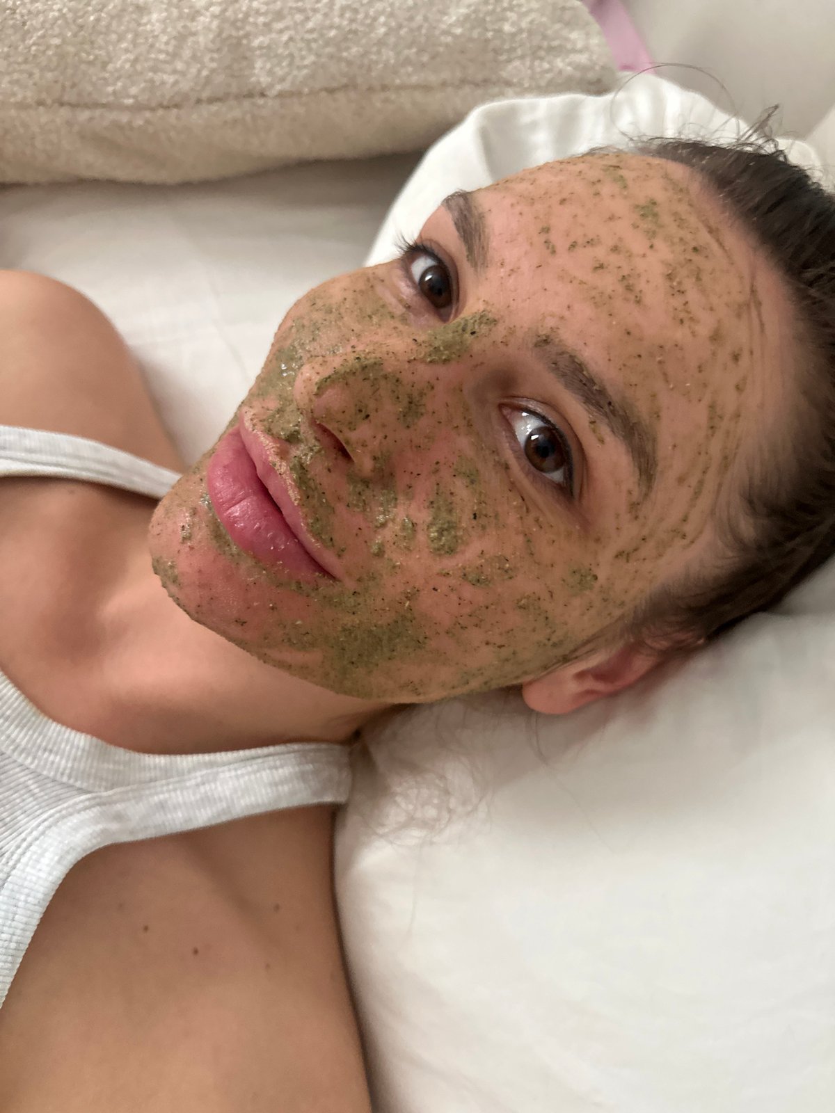 Moscow resident applies green face mask during morning skincare routine