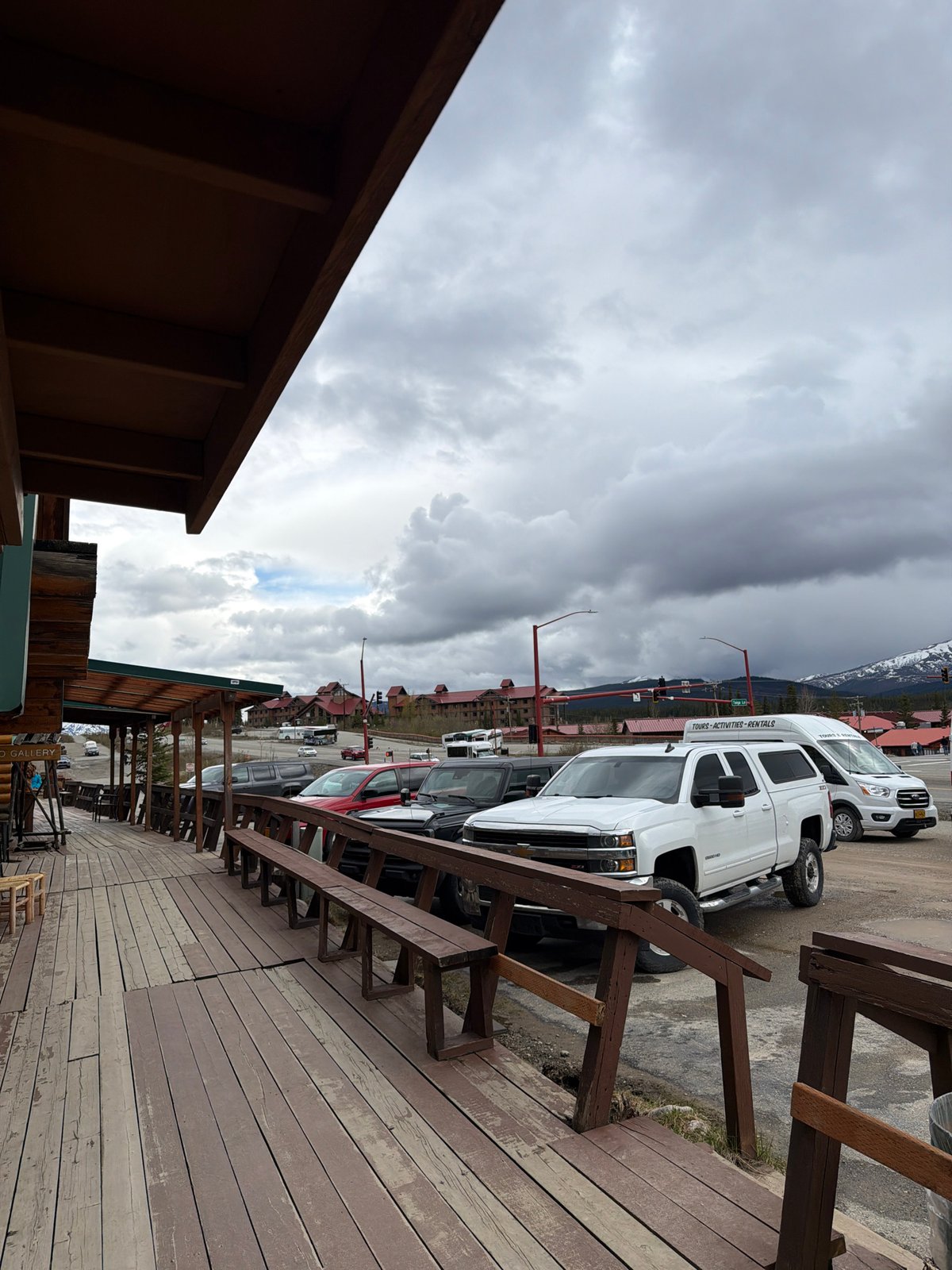 Nighttime deck view captured at Denali Park shows vehicles, buildings
