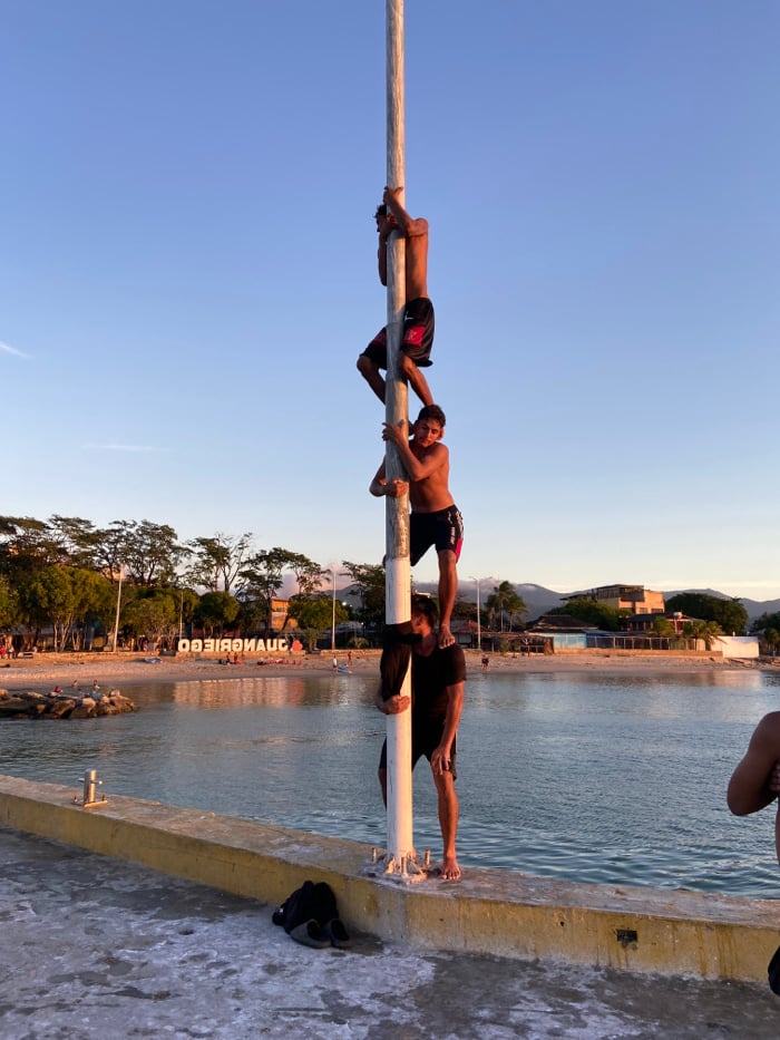Evening waterfront activities documented in Juan Griego, Venezuela