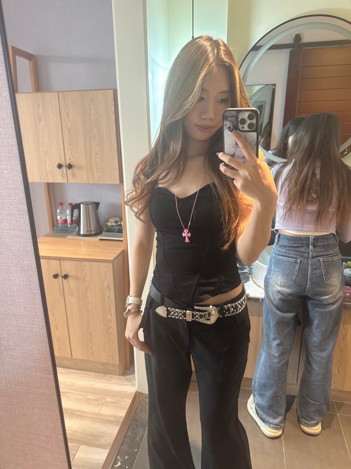 Woman takes mirror selfies in Jiayuguan hotel room