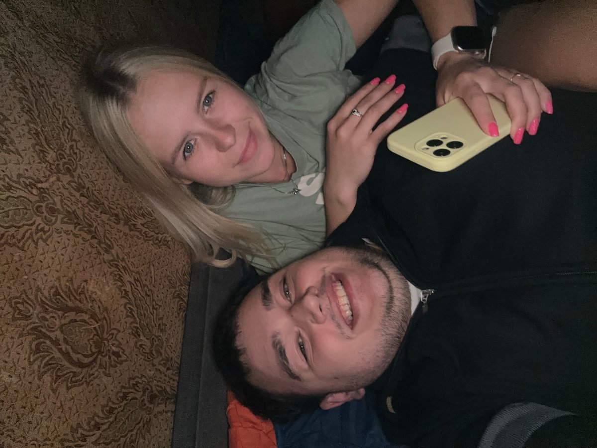 Lazy afternoon indoors, couple hanging out and taking selfies