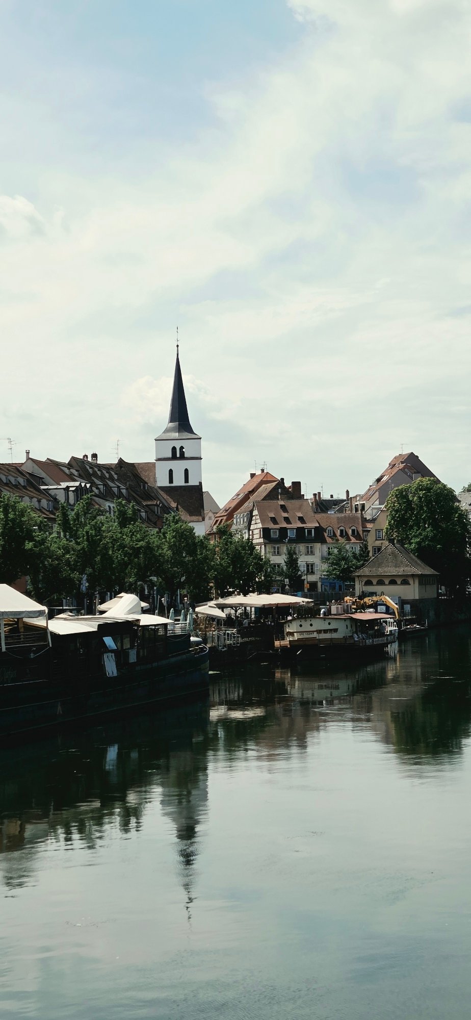 Sunny morning in Strasbourg's historic center, canals and cyclists