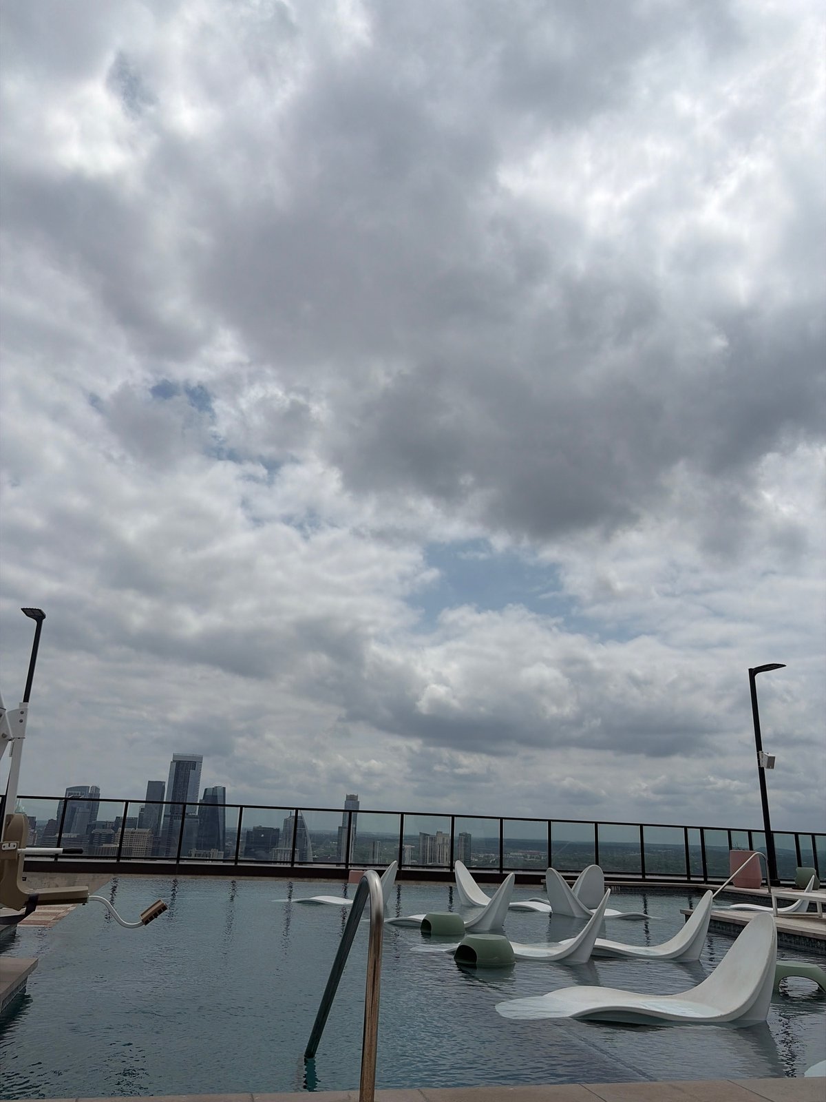 Rooftop view captures Austin skyline under dramatic evening clouds