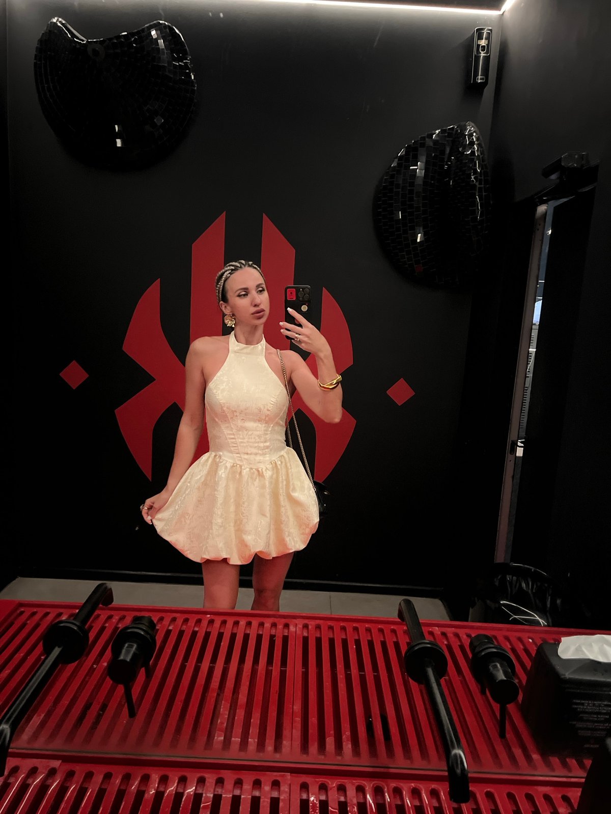 Mirror selfie in a Sochi restroom, cream bubble-skirt dress