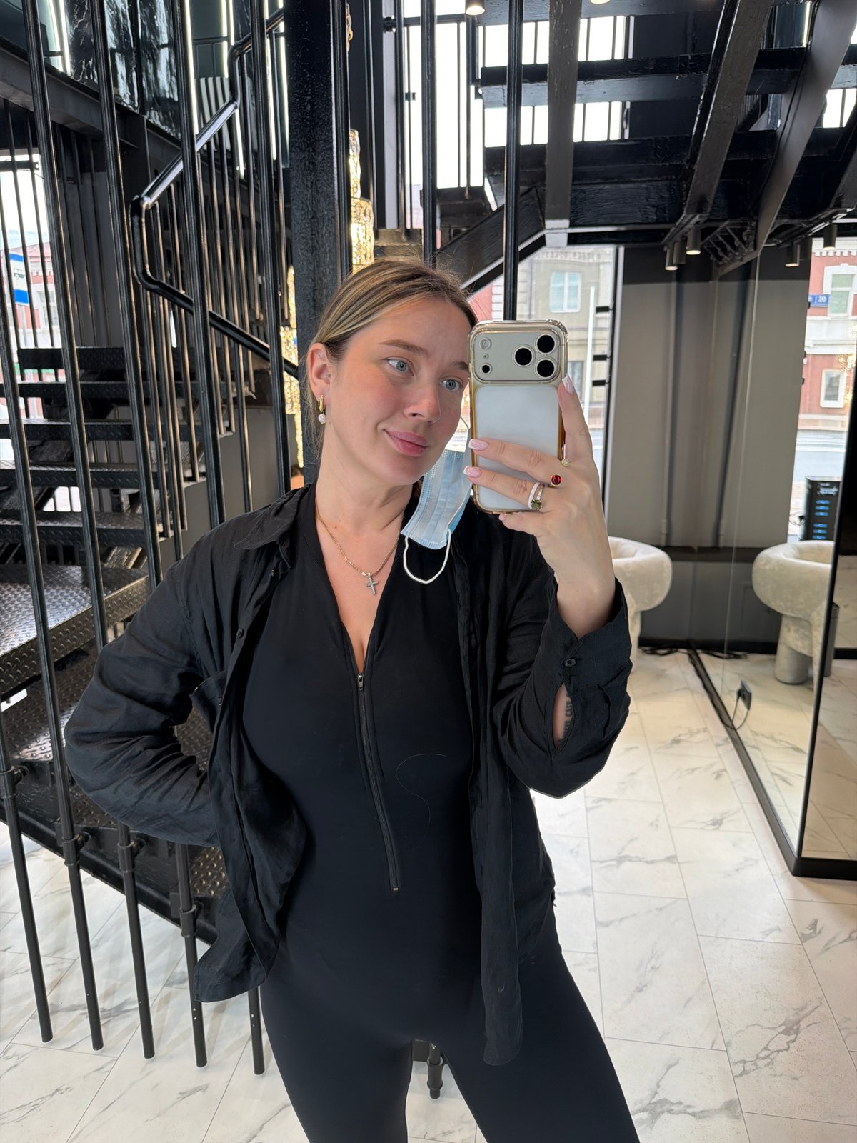 Woman takes selfie on Moscow staircase wearing mask