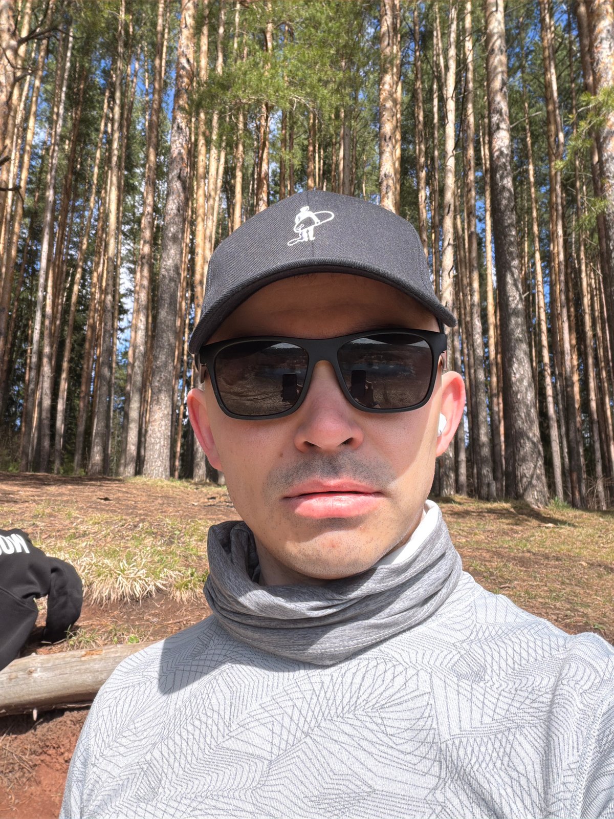 Man takes forest selfie under partly cloudy sky in Izhevsk
