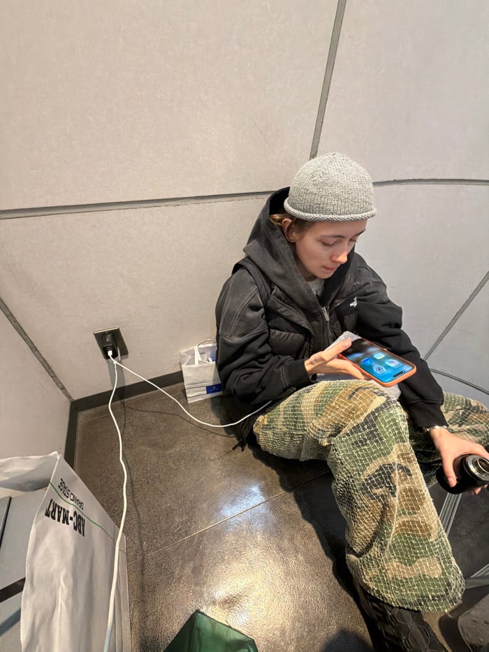 Person sits in Chuo public space, TGIF display observed