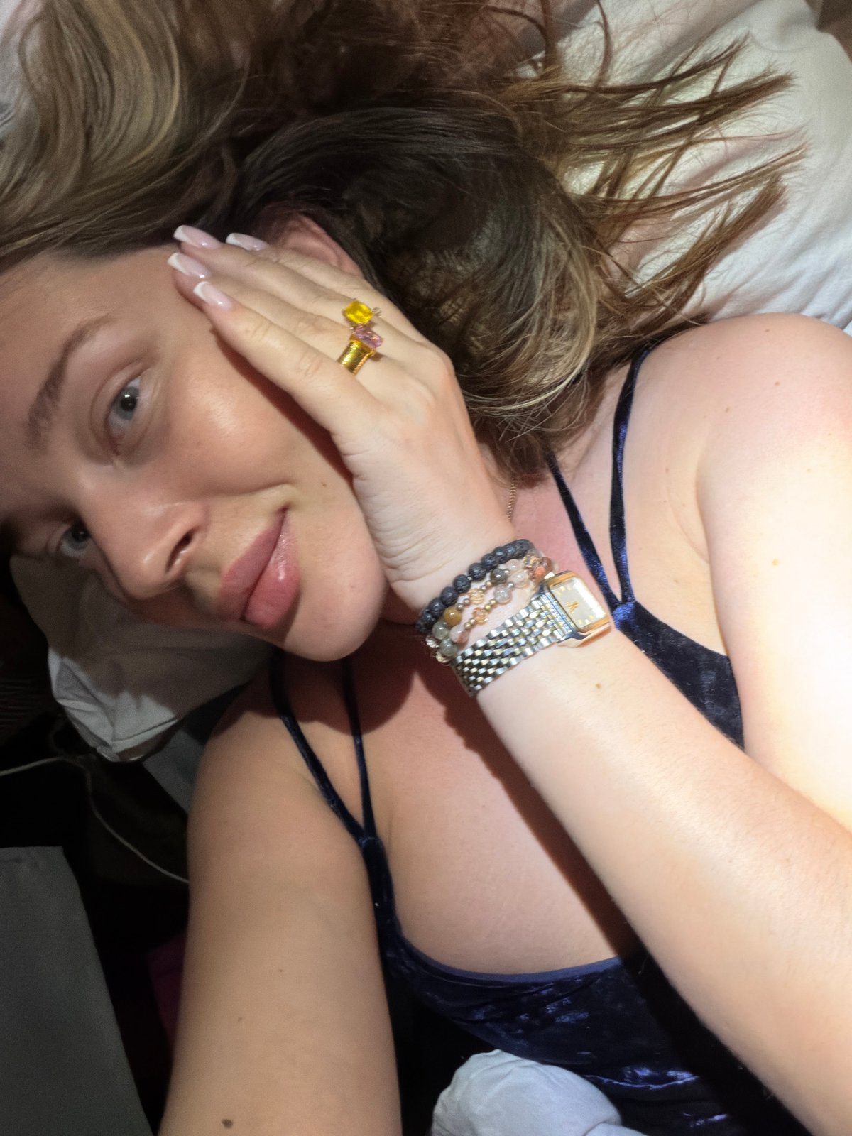 Woman resting indoors wearing jewelry observed in Высокая Гора
