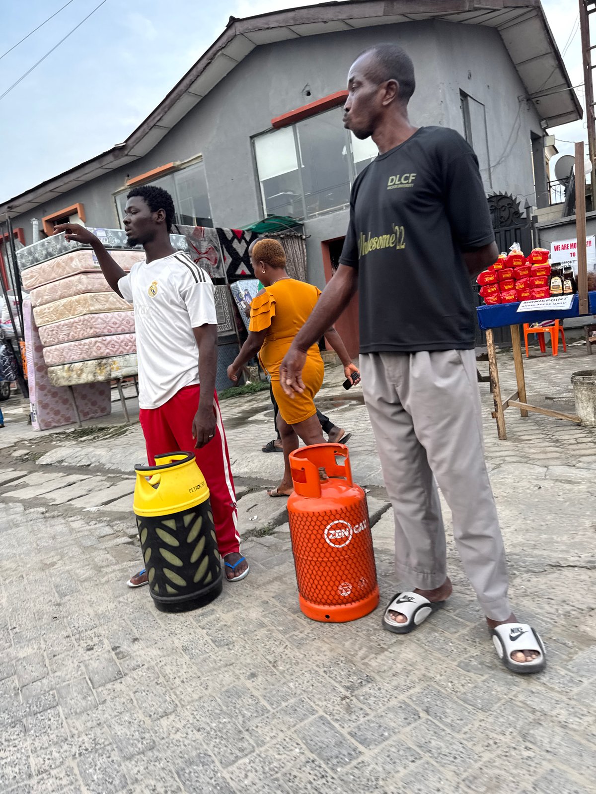 Everyday street activity outside shops in Ado, Nigeria