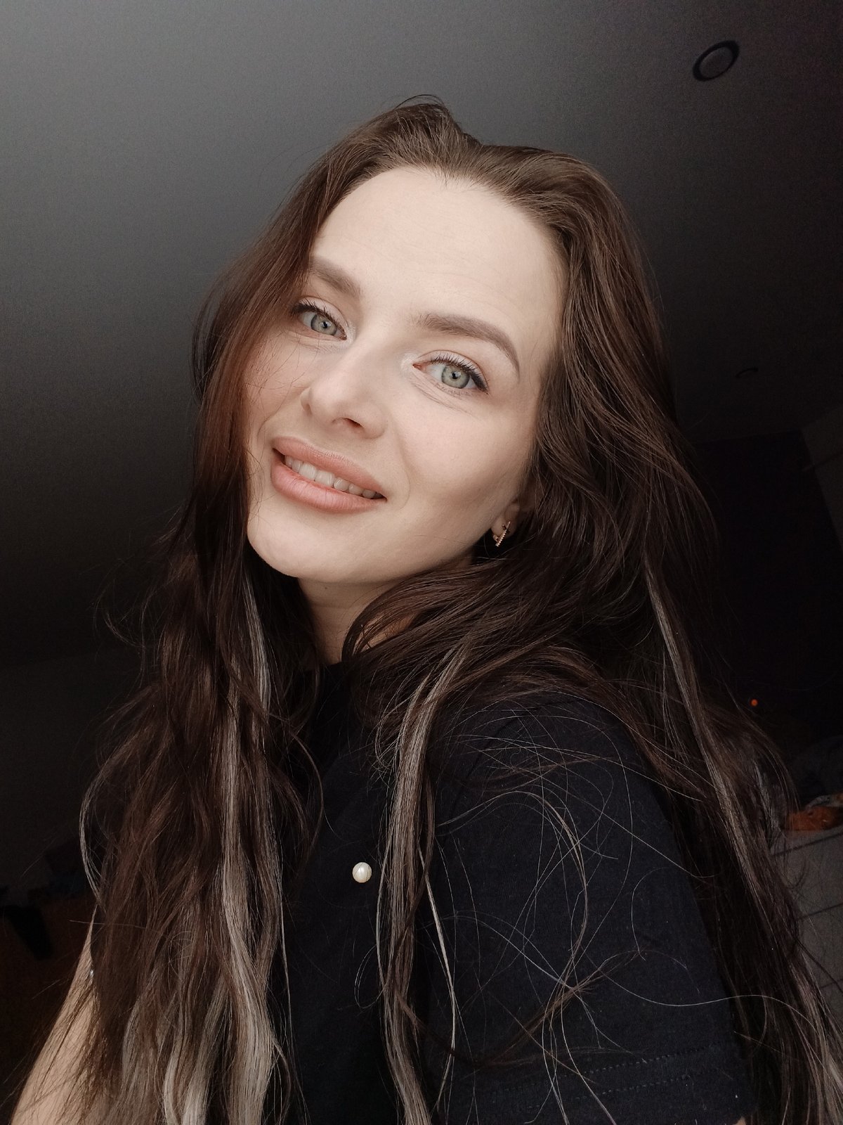 Woman photographed smiling indoors in Rusalevka, Russia