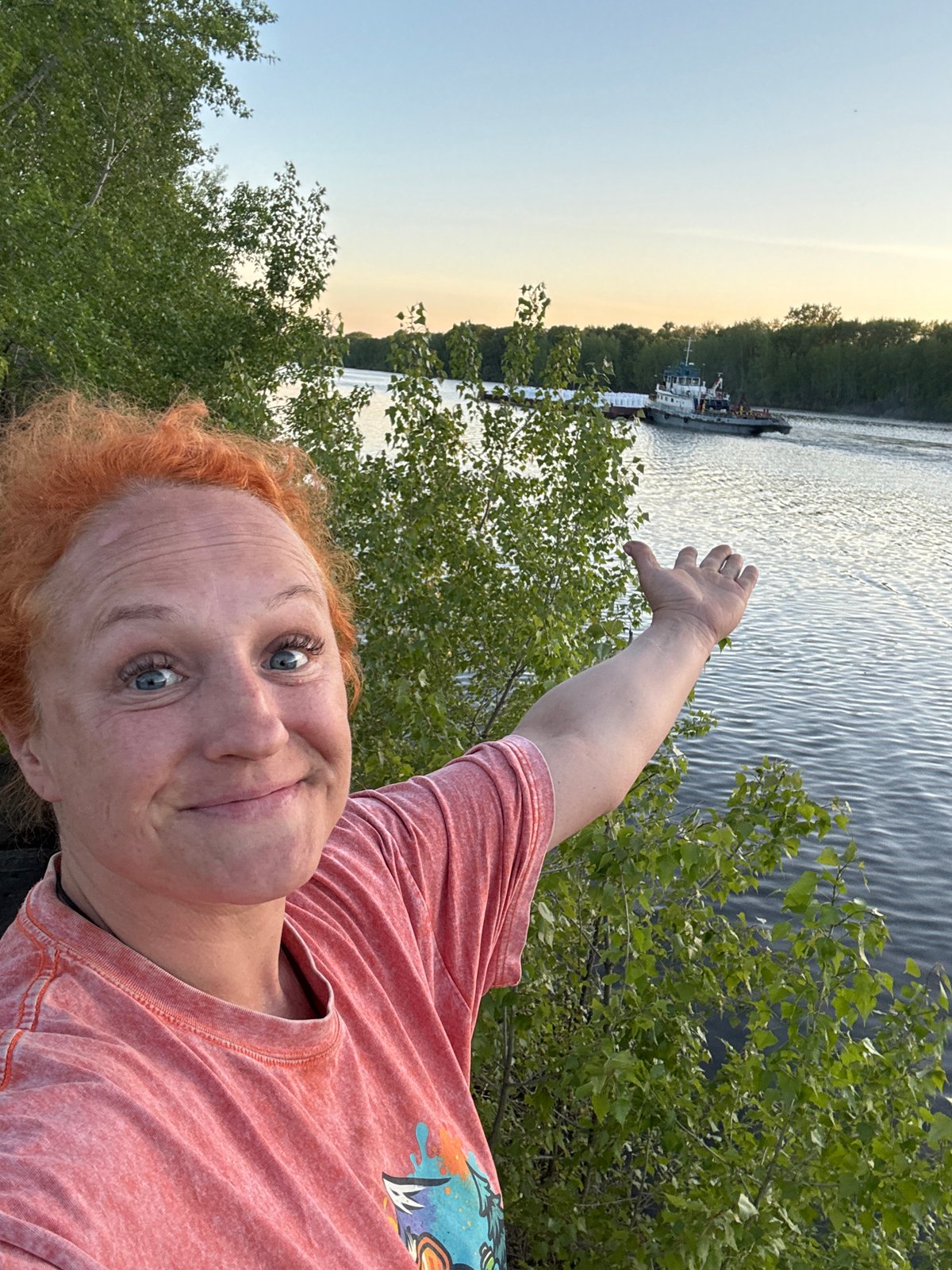 Tugboat pushes barge on Kama River near Chaikovsky