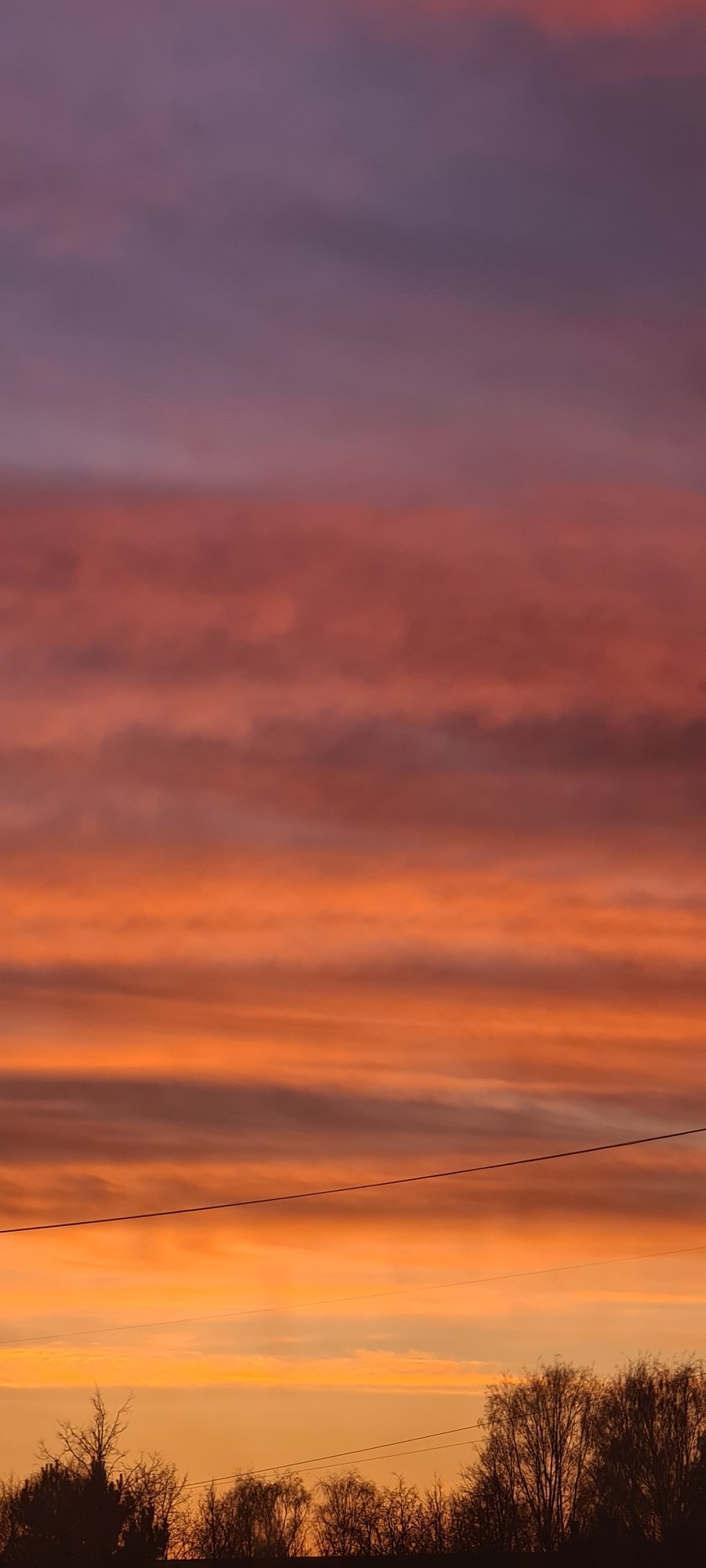 Colorful sunset observed in Riga displaying purple to yellow hues