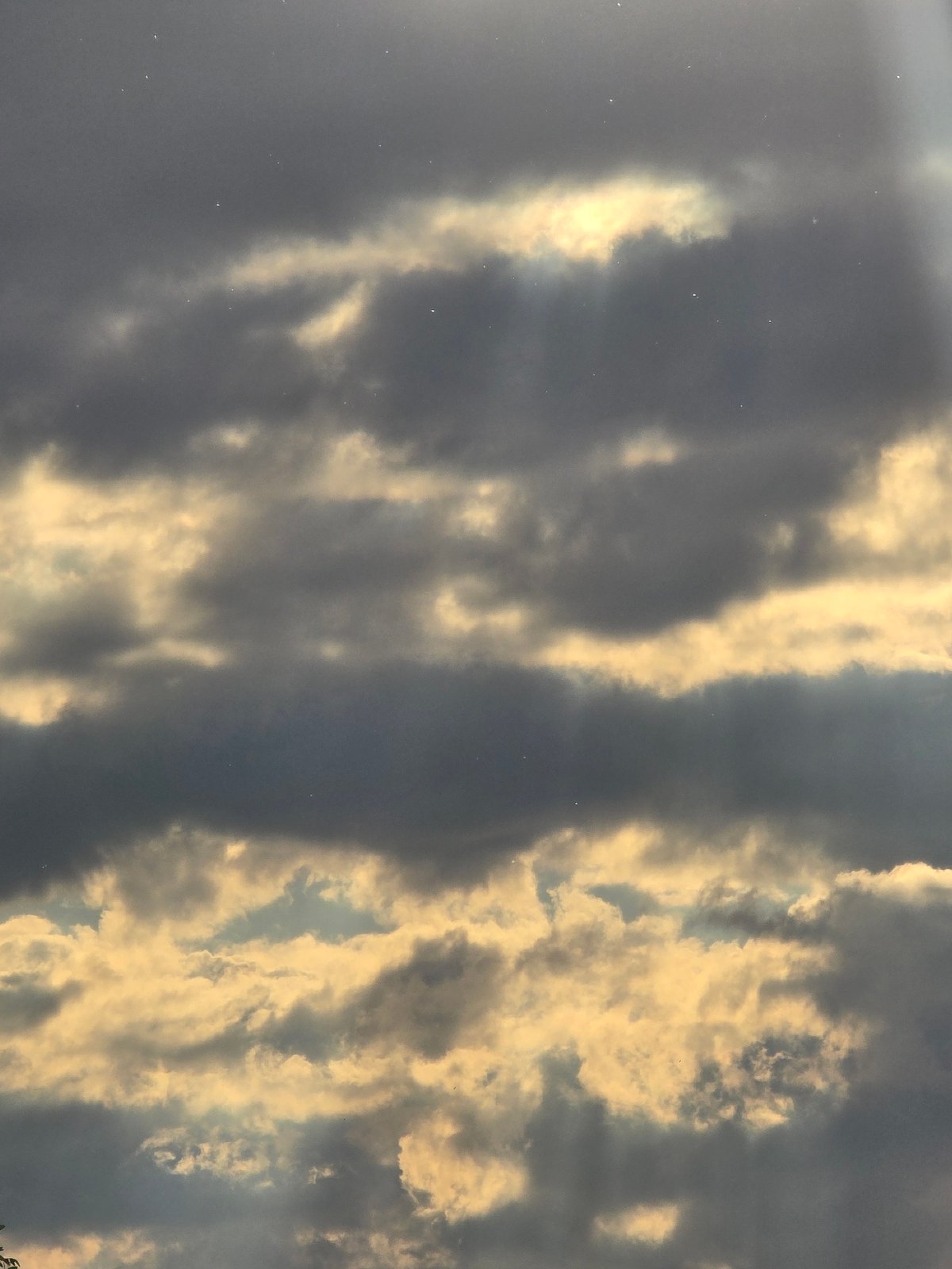 Construction crane observed against dramatic sunset clouds