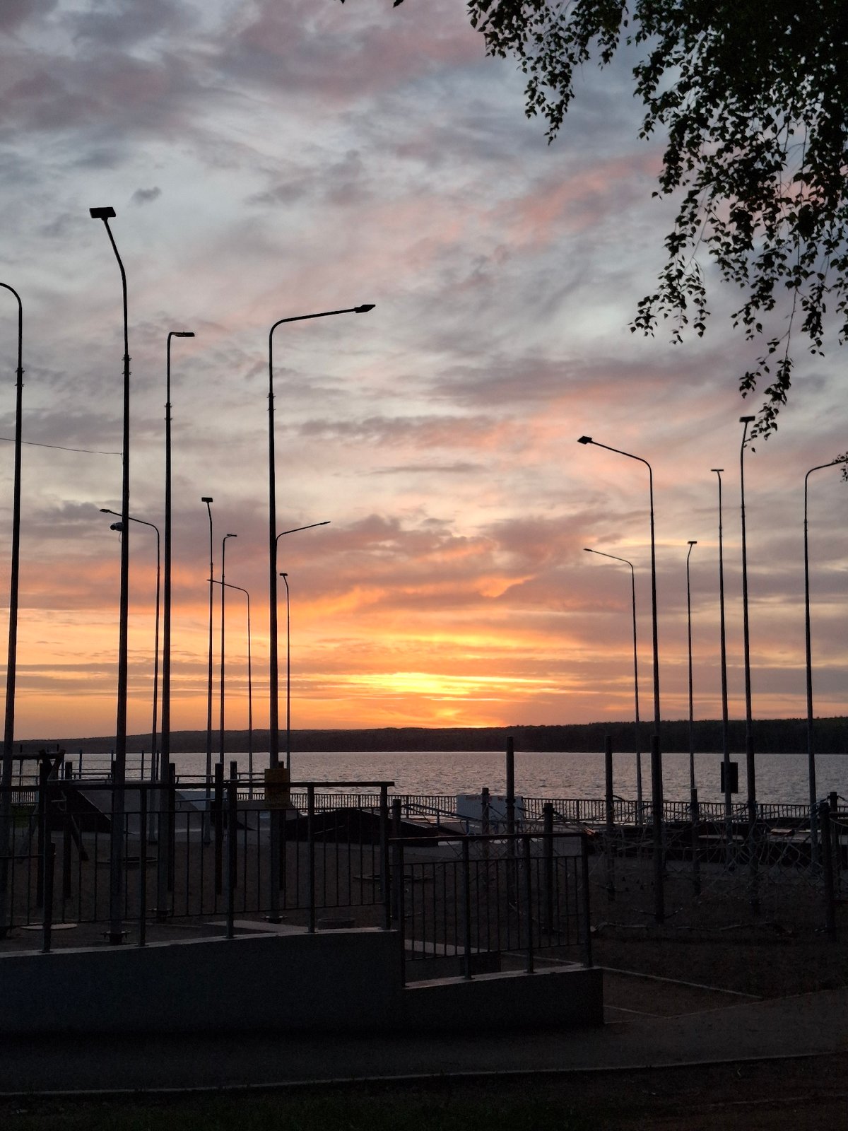 Sunset observed along Chaikovsky waterfront with colorful sky display