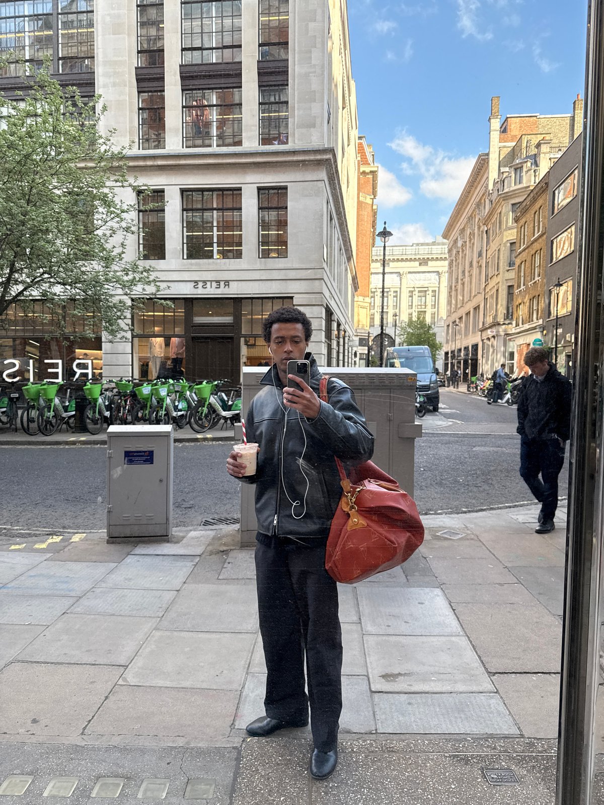 Man Takes Selfie in London Shop Window Reflection