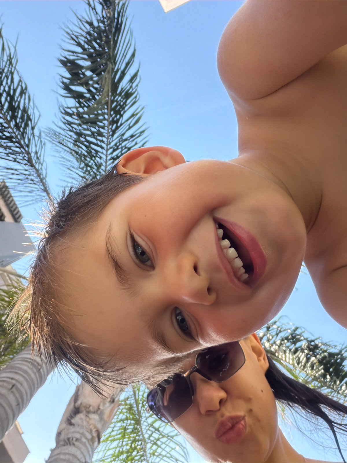 Mother and child enjoy morning poolside leisure time in Valencia