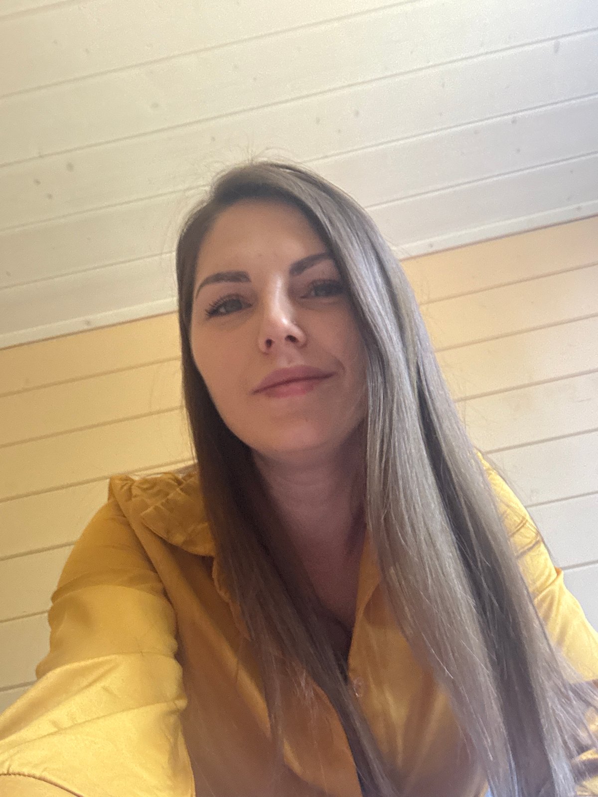 Woman in yellow top photographed indoors in Раздолье, Russia