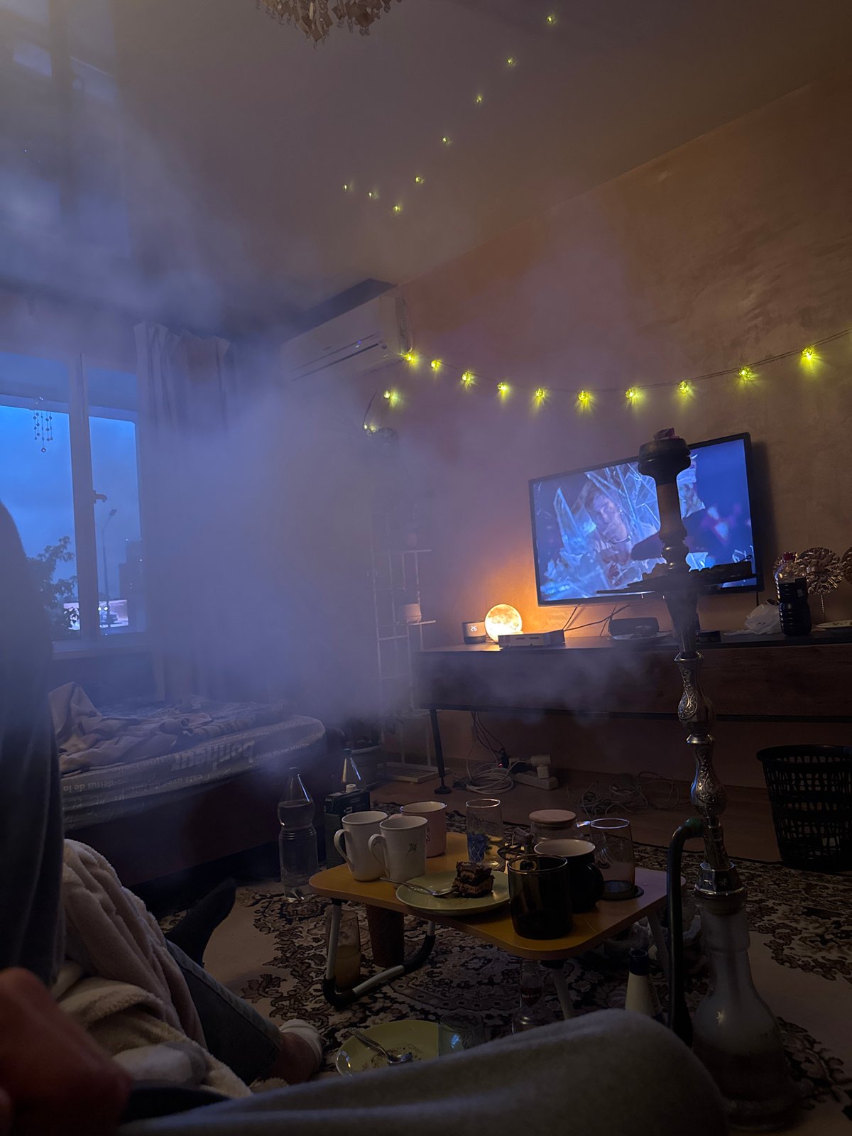 Man relaxes with vape, TV in Perm apartment