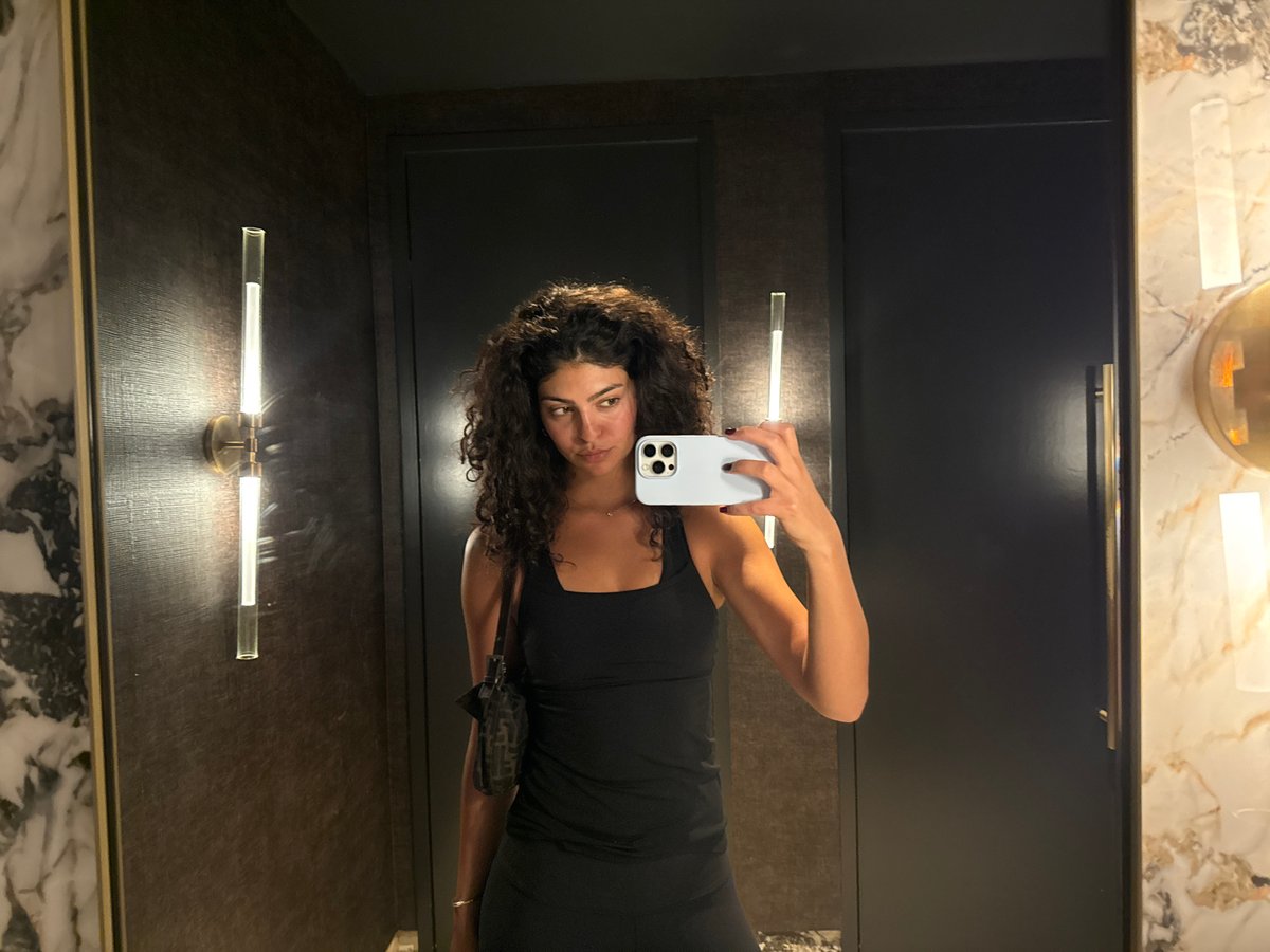 Woman takes mirror selfie in upscale West Hollywood interior