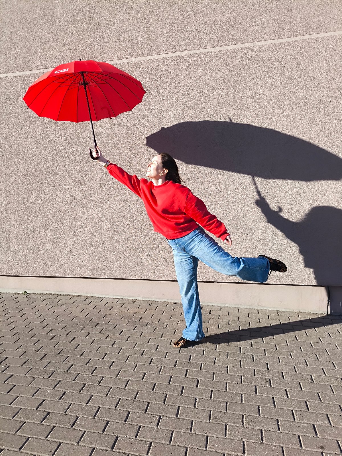 Woman poses with CGI umbrella in Riga street scene