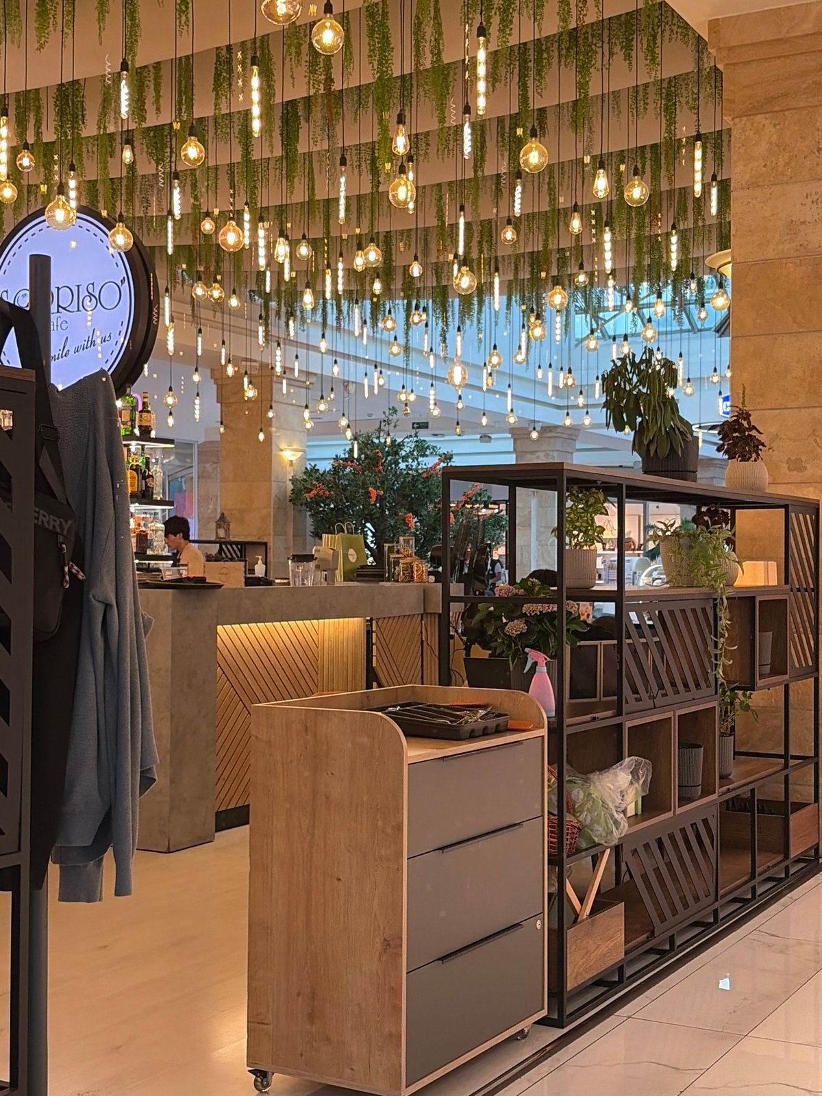 Wandering a well-decorated indoor mall with cafes and retail