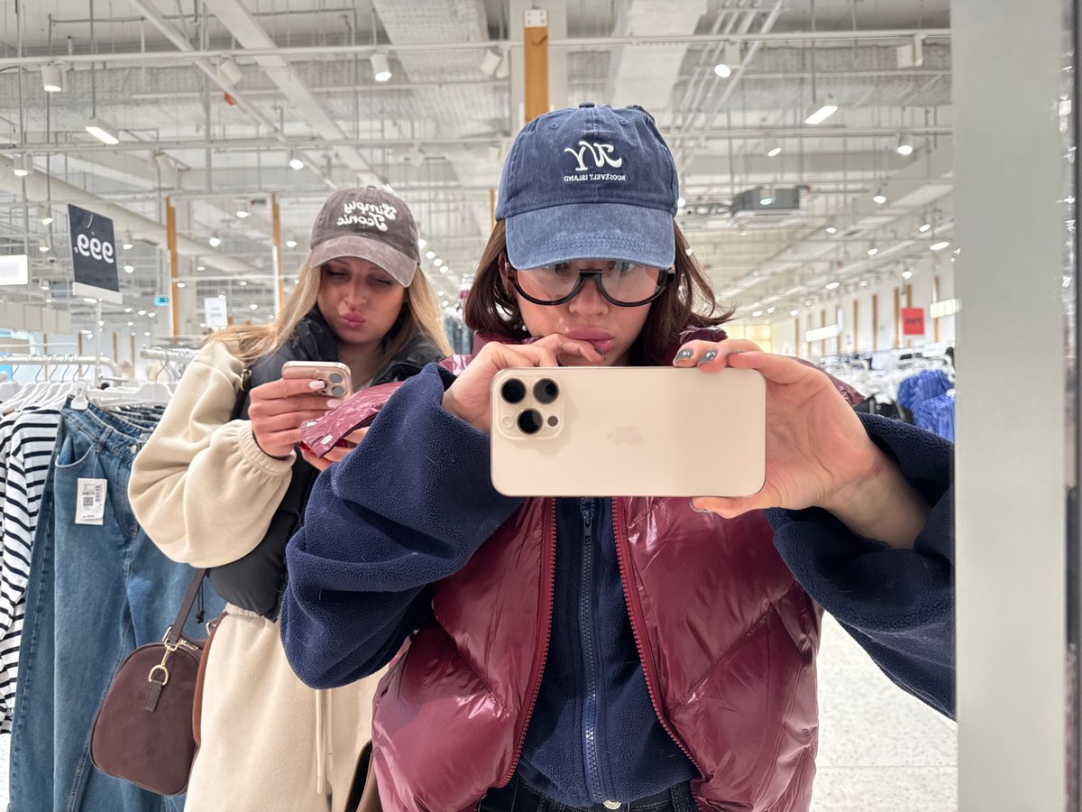 Young women take mirror selfies in Perm shopping mall