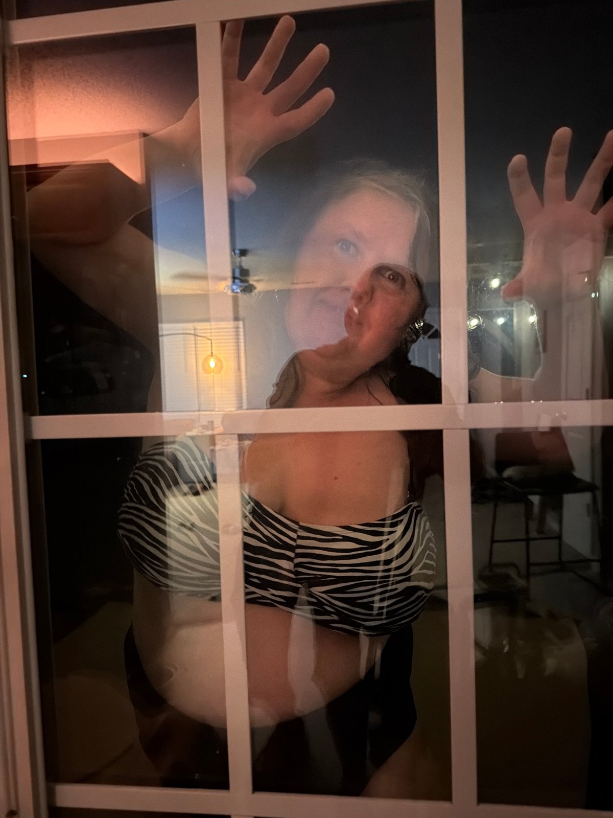 Late-night home moments: window reflection and a resting dog