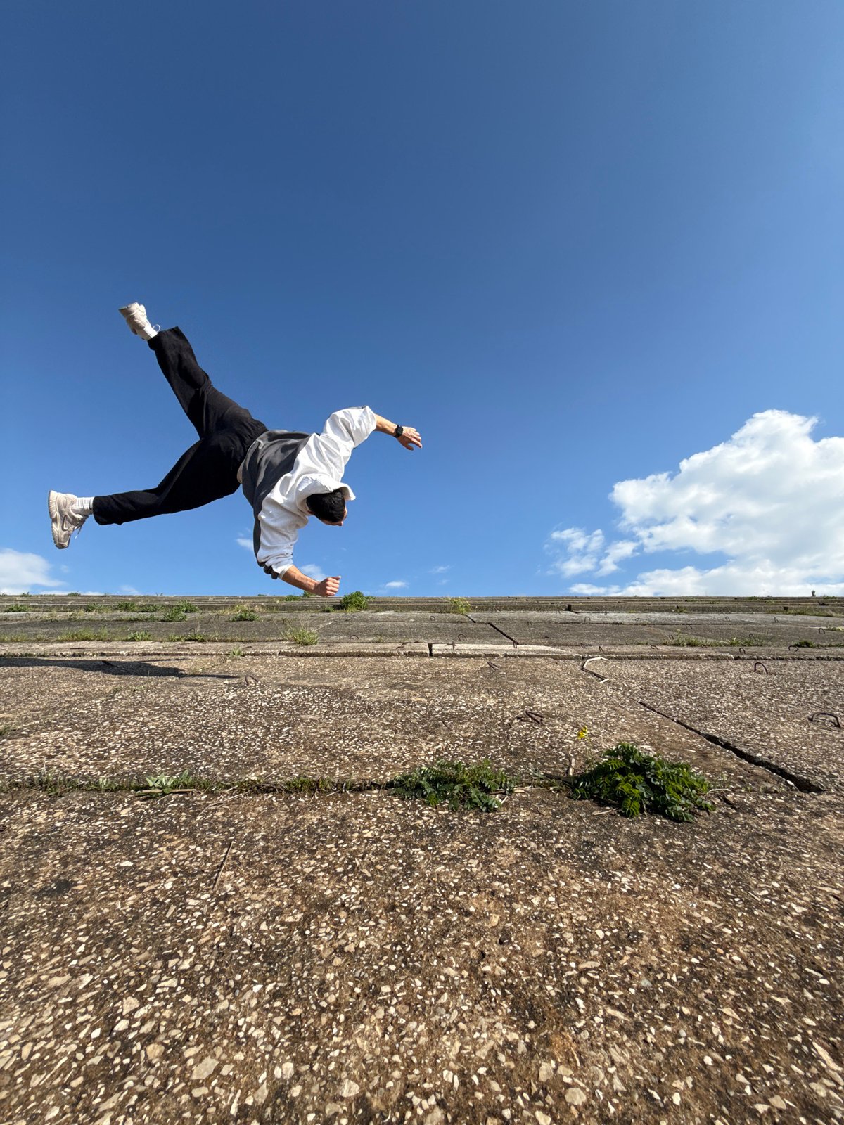 Person performs acrobatics on bridge structure in Shumen