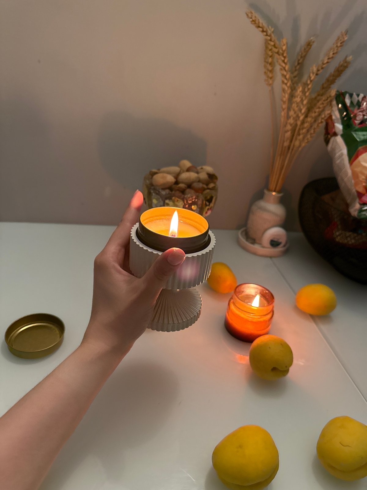 Still life photography session with candles and seasonal fruits