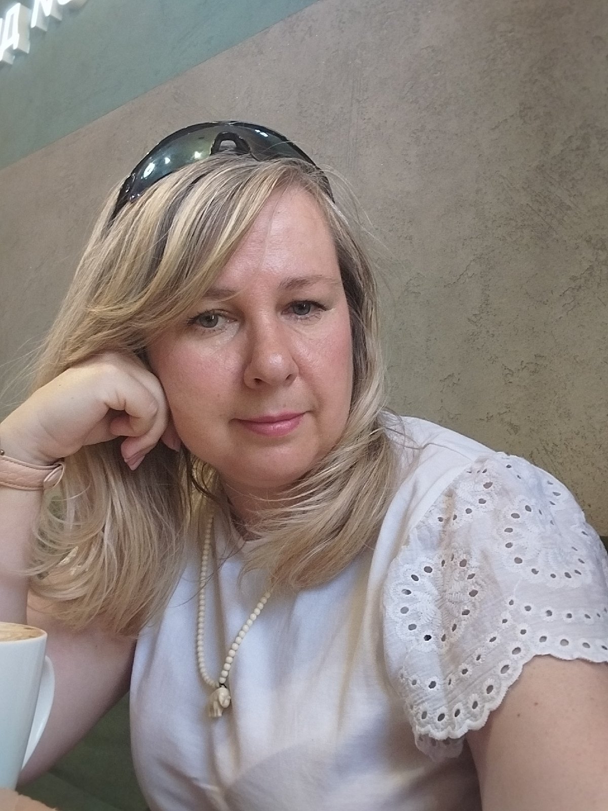 Woman enjoys coffee and cake at Orenburg cafe