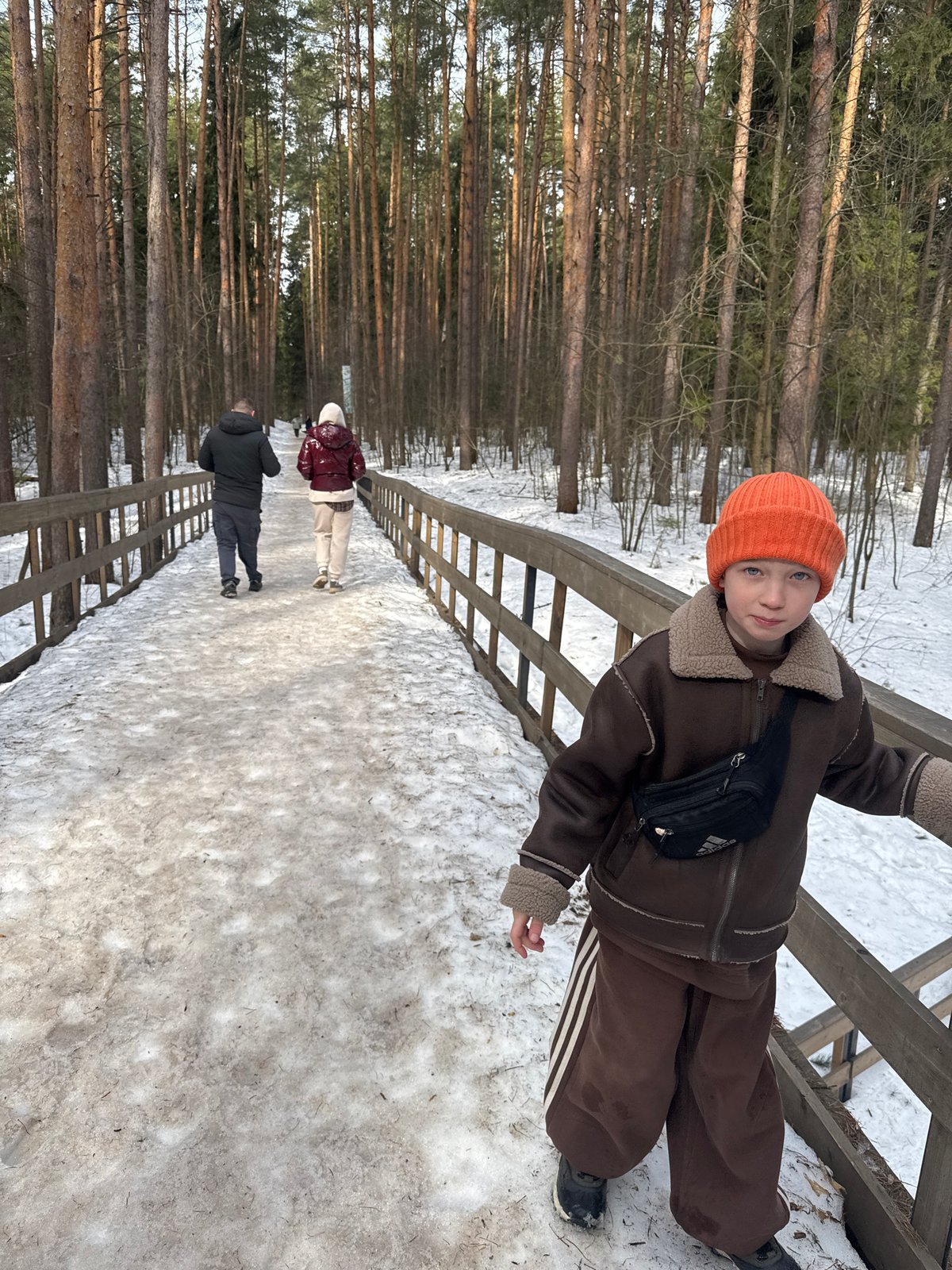 Child explores snowy park in Votkinsk, Russia winter morning