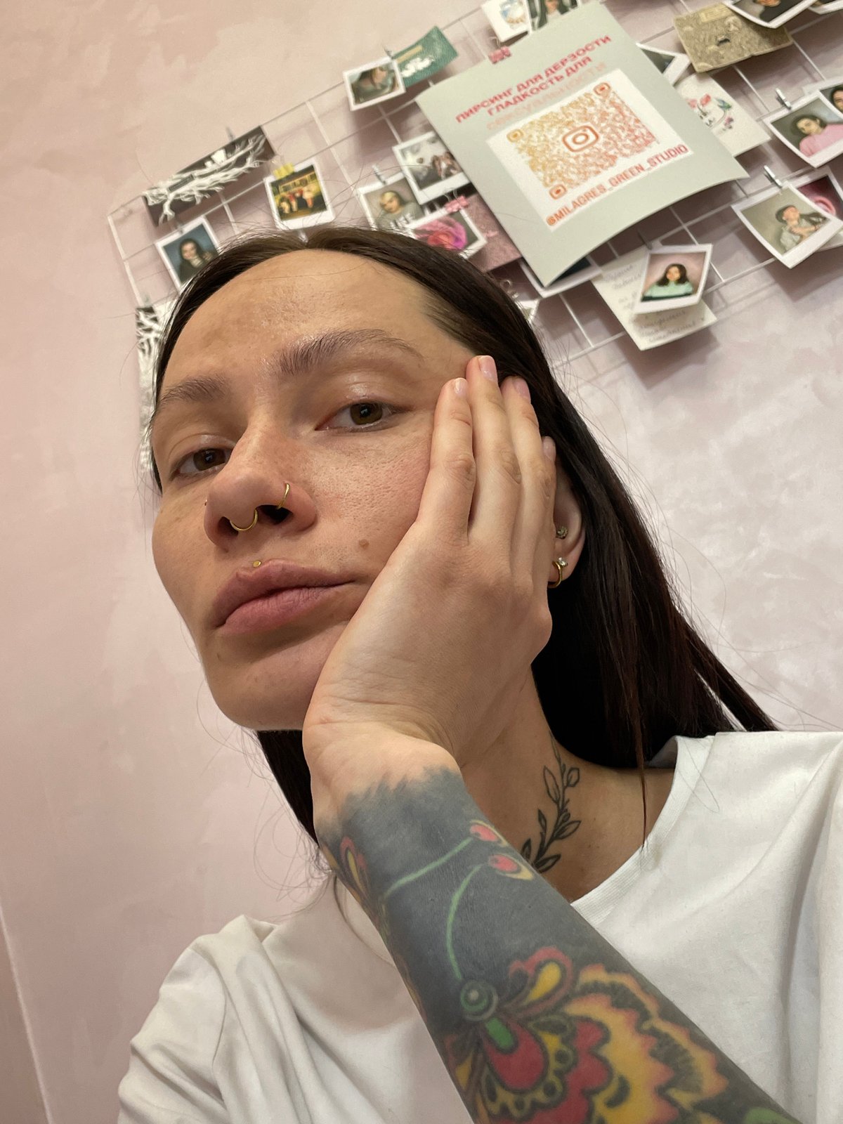 Tattooed person photographed against pink wall in Izhevsk