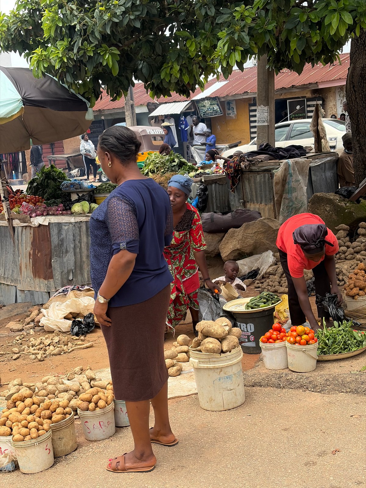 Morning street life in Jos, Nigeria — markets, motos, and foot traffic