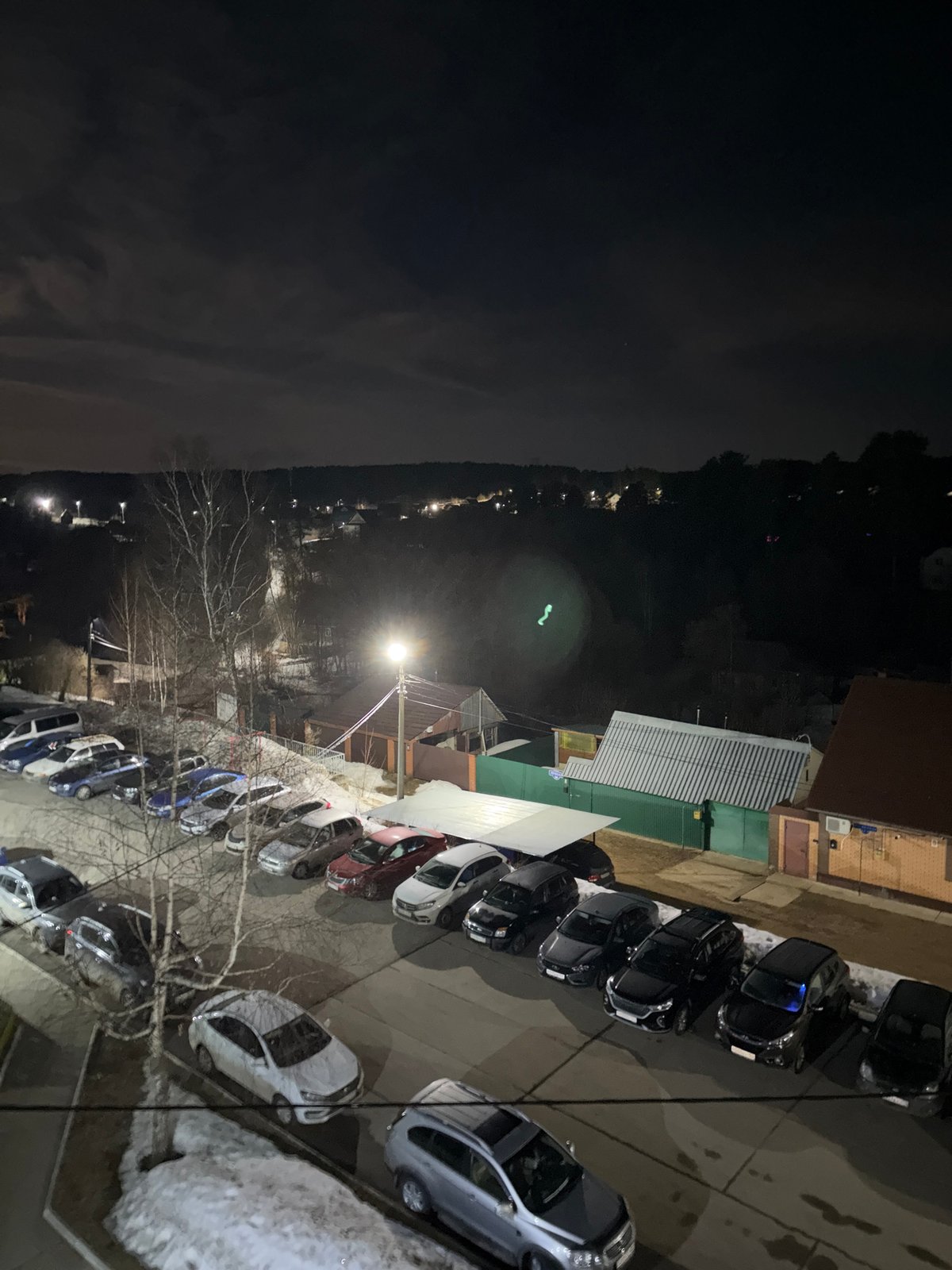 Full moon illuminates nighttime cityscape in Chaikovsky, Russia