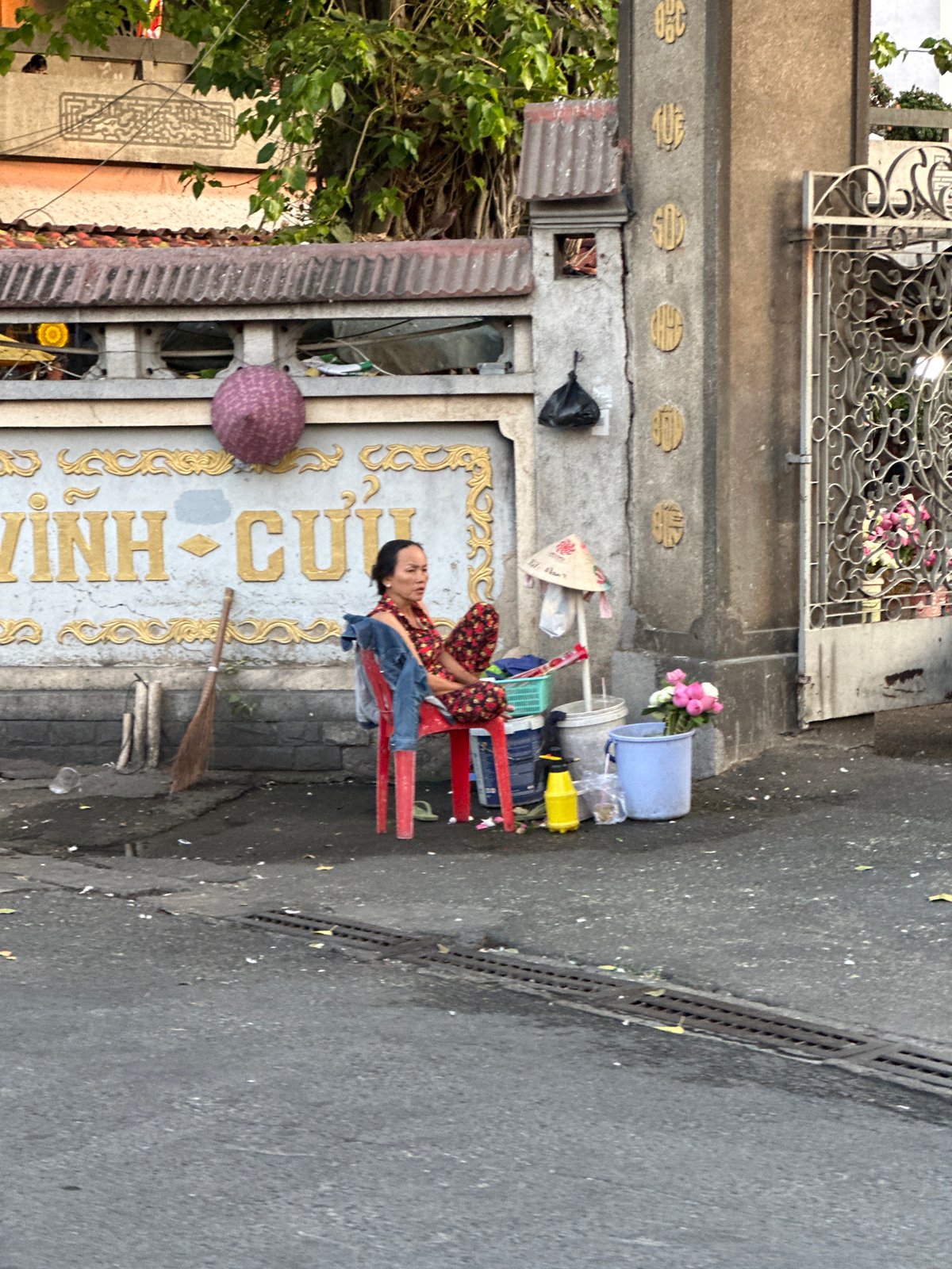 Woman rests on sidewalk chair in Thủ Đức, Vietnam