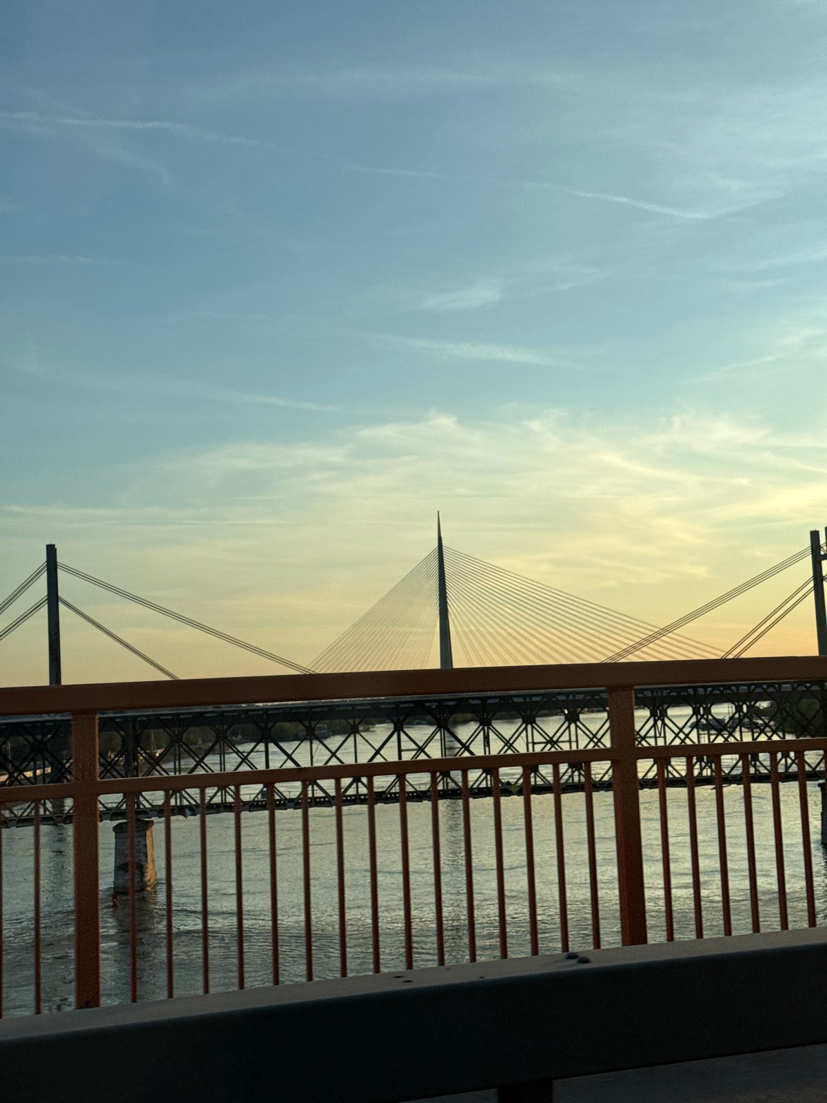 Ada Bridge photographed through orange railings in Belgrade