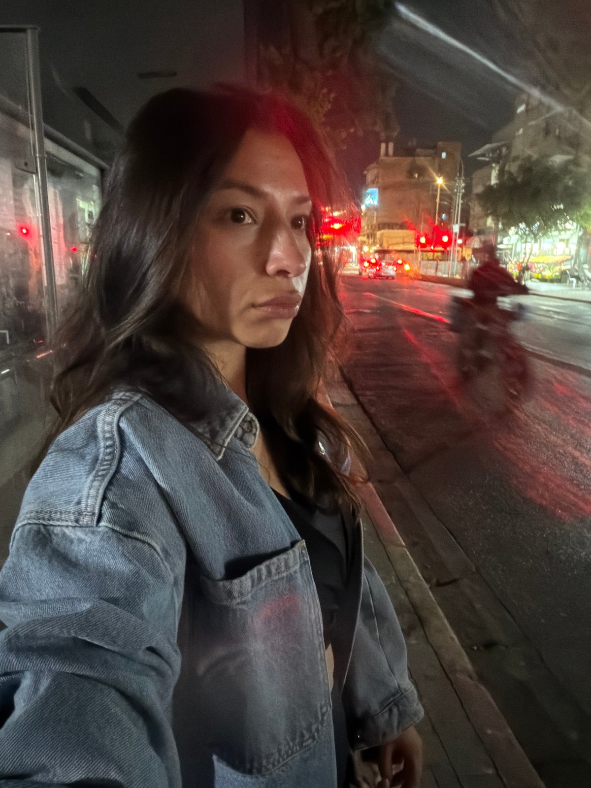 Woman photographed on Tel Aviv street with traffic backdrop
