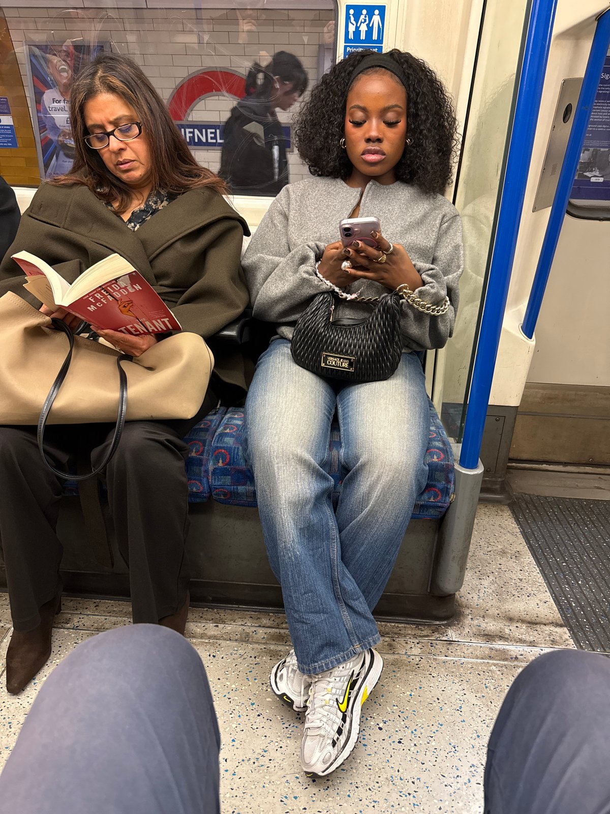 Passengers ride London Underground train during evening commute