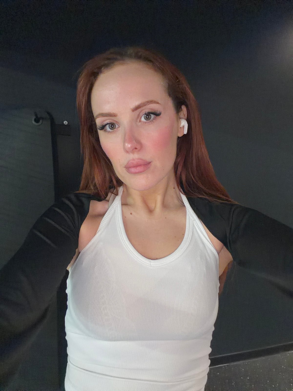 Woman takes multiple selfies indoors in Paris